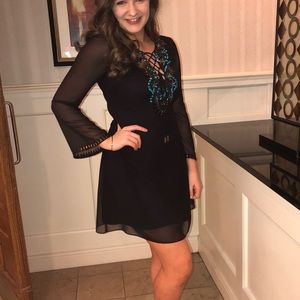 Shail K black long sleeve tie shift dress with blue and gold jewels